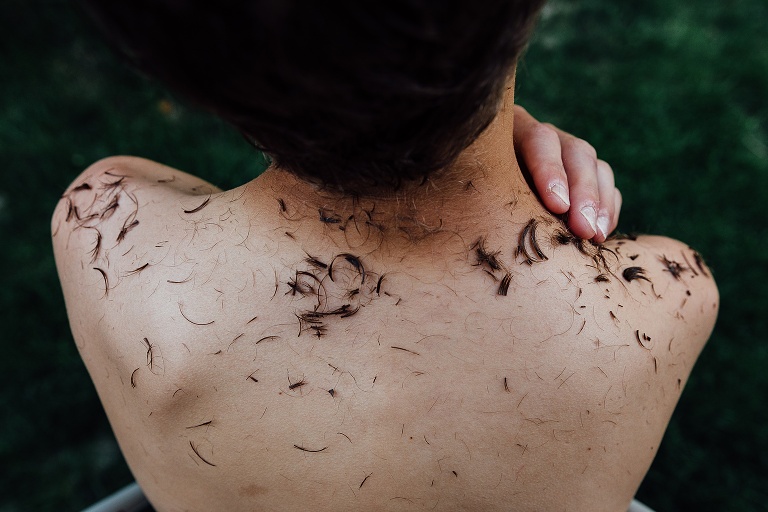 view of freshly clipped hair on back and shoulders