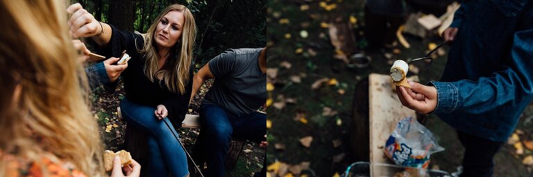 Mom brushes hair out of child's eye while boy places graham cracker under roasted marshmallow to make a s'mores