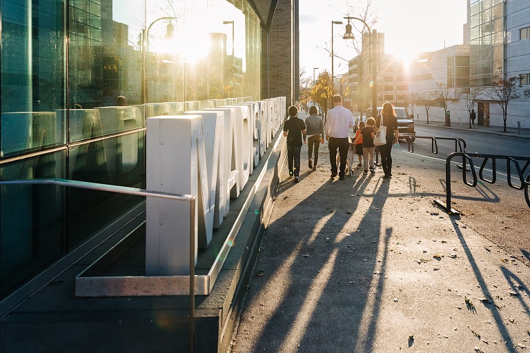 Family of six walks into sunset outside Madison library