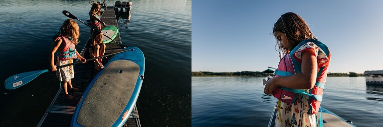 two girls get ready to go stand-up-paddleboarding. 