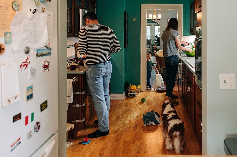 Mom, Dad, toddler son, and family dog all in the kitchen while making Saturday pancakes