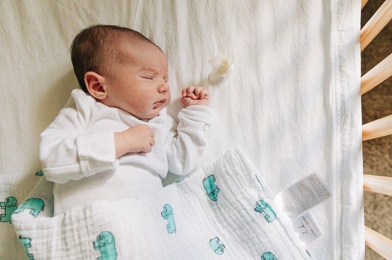profile of sleeping newborn on a quiet summer morning 