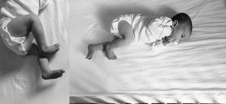 black and white of newborn in crib on white sheets. 