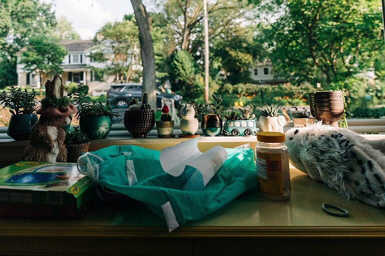 detail shot of tiny plants lining the window sill on summer nights