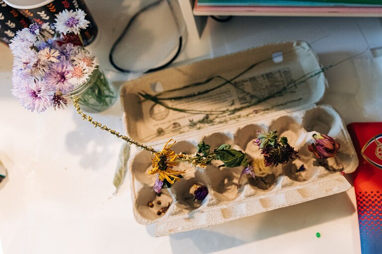 top down detail view of a recycled egg carton filled with dried garden flowers