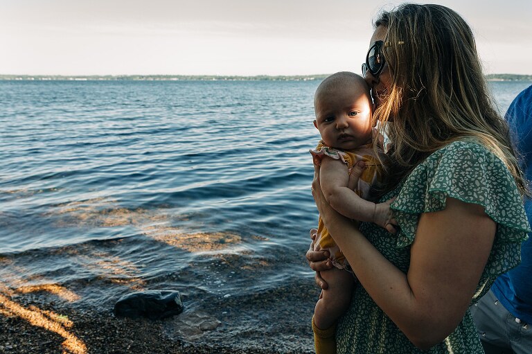 direct light on baby's face while at the lake before a family is moving on to another city