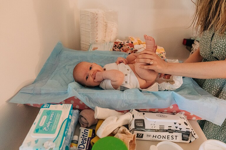baby gets changed while family packs up to be moving on
