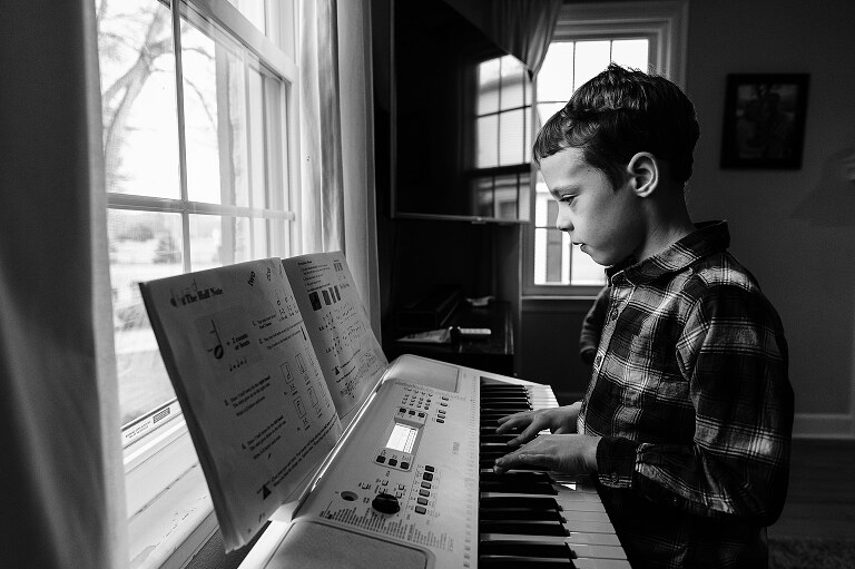 boy reads music on a keyboard 