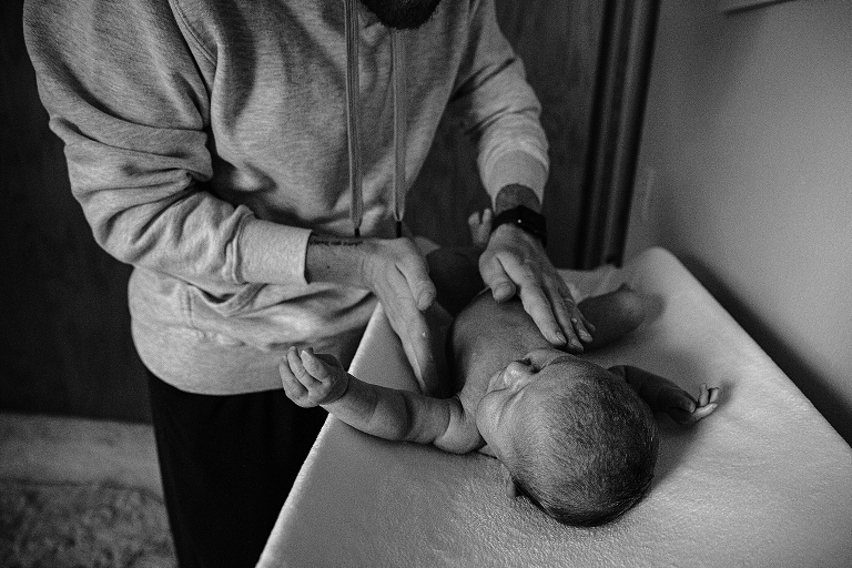 Father plays with newborn. Life with newborn