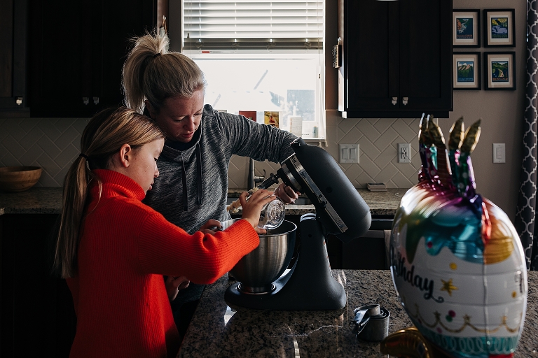 mothers and daughter use a kitchen mixer together