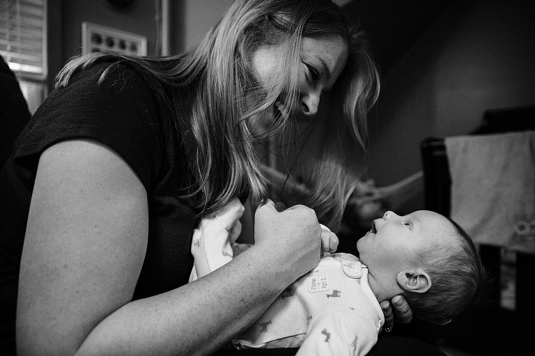 Mom and newborn smile and engage with each other 
