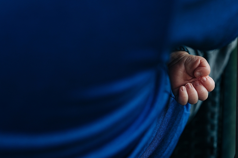close up of newborn's tiny hands in a curled position 