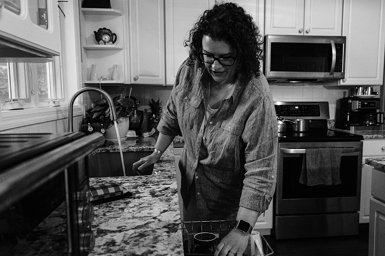 Black and white: mother does dishes after evening with whole family