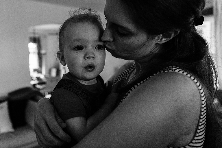 Young son is embraced lovingly by mother with tears in his eyes