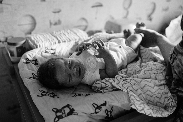 black and white baby cries on changing table 
