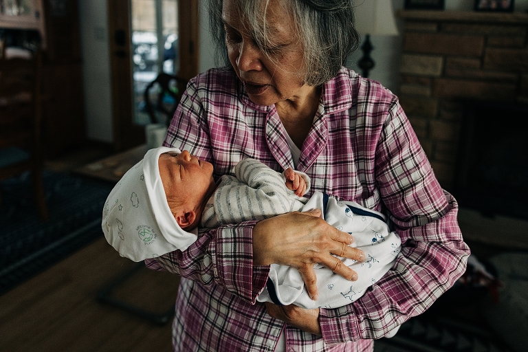 Grandma holds newborn winter baby