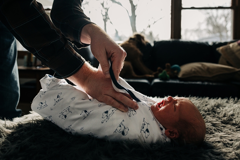 winter newborn at home in a cozy swaddle
