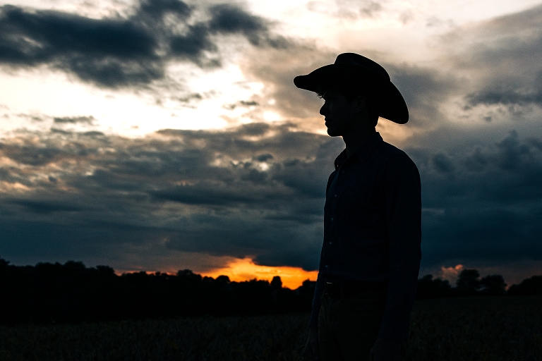 senior boy against dramatic sky