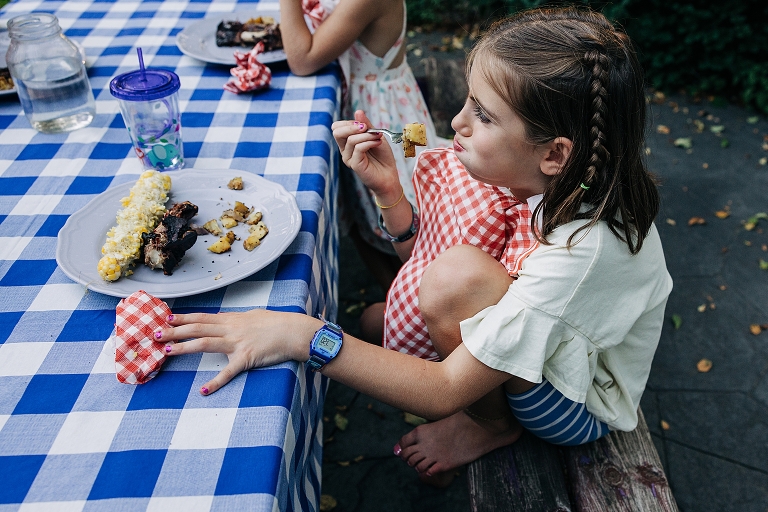 Girl winces while eating chopped potatoes
