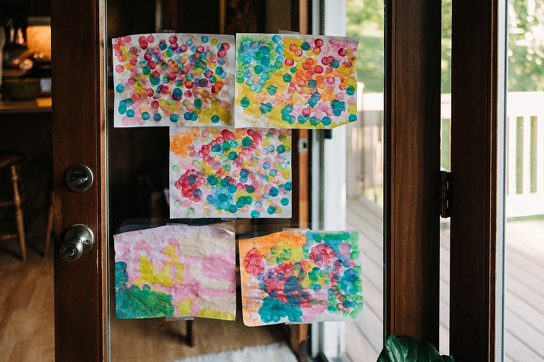 Glass door covered with five watercolor paintings 