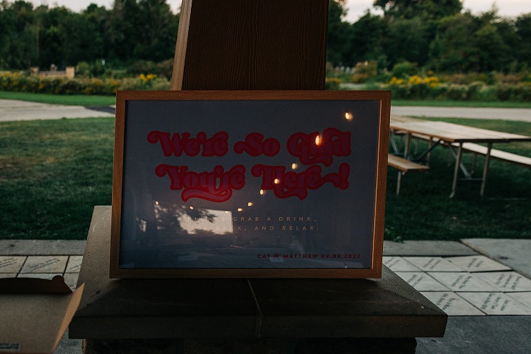 Framed invitation for the Tenney Park Documentary Wedding with the park in the background