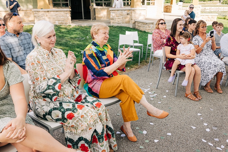 wide shot shows guests watching the kiss between the bride and groom 
