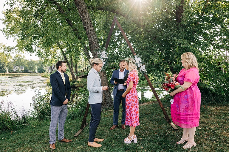 Close up angle of Tenney Park Documentary Wedding ceremony shows bride, groom, bridesmaid, bestman, and officiant