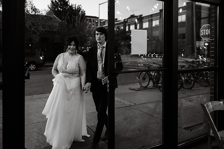 Black and white: newly wed couple walk into restaurant for dinner after Fall Wedding At Home