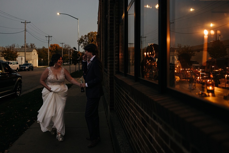 Husband and wife walk down sidewalk outside the restaurant they plan to eat at