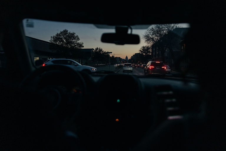Husband drives jeep down Washington Avenue, with capitol building in the background
