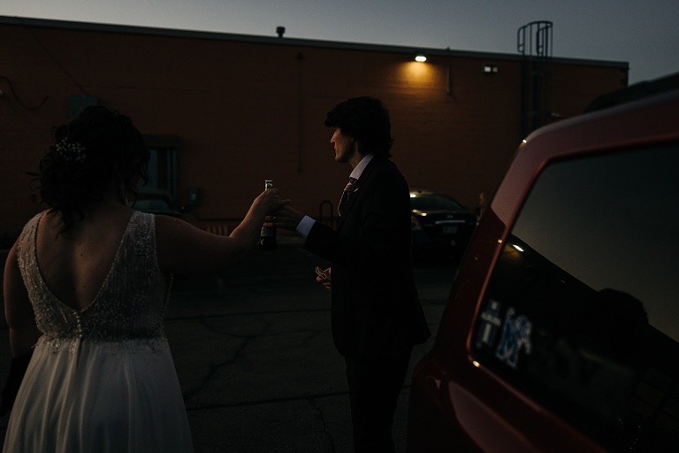 Wife grants husband a sip of her Coca Cola after exiting jeep and arriving at their destination 