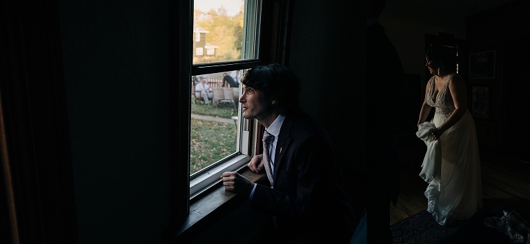 Bride and groom look outside of their home at the ceremony venue before "Fall Wedding At Home" starts 