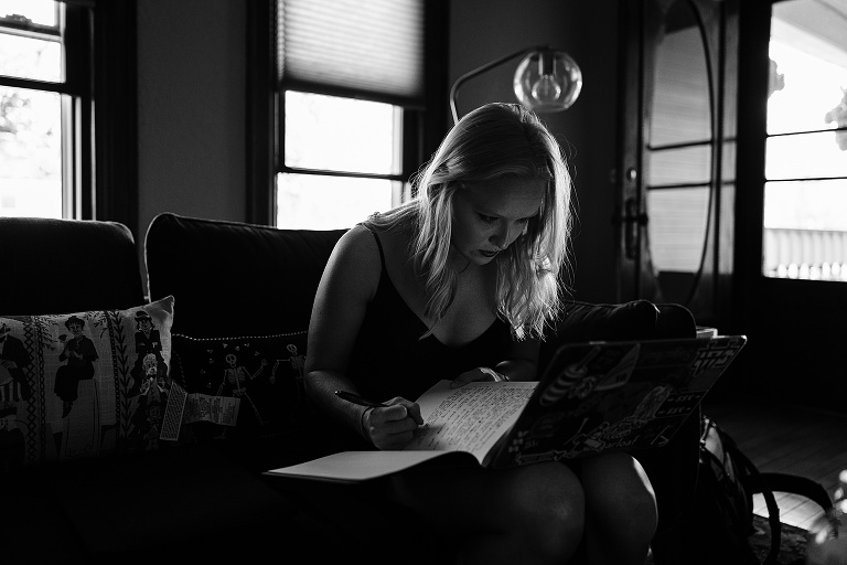 Black and white: woman copies information from a computer to her notebook