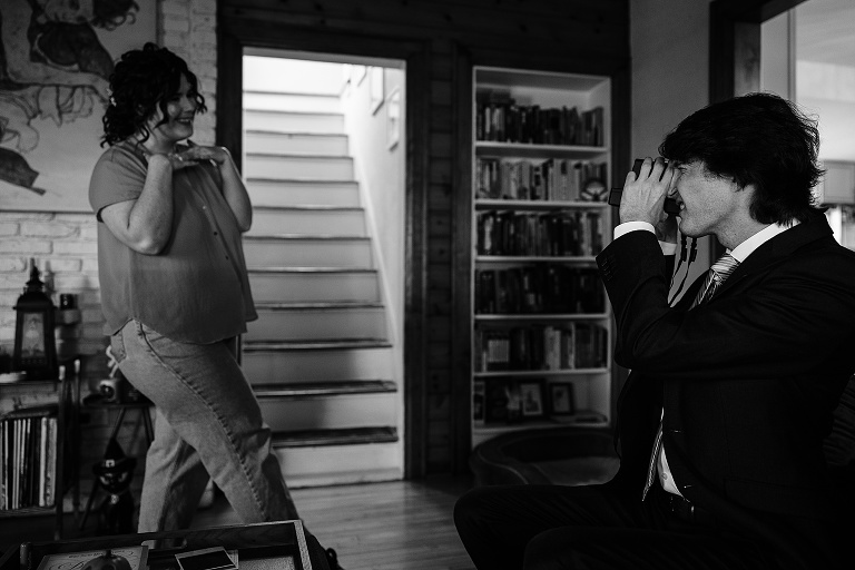 Black and white: groom photographs bride still in casual clothing before Fall Wedding At Home 