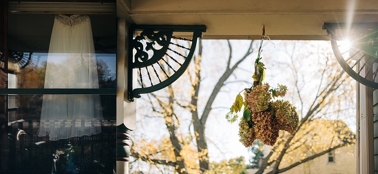 Hydrangea hangs from door frame as daylight flows into home